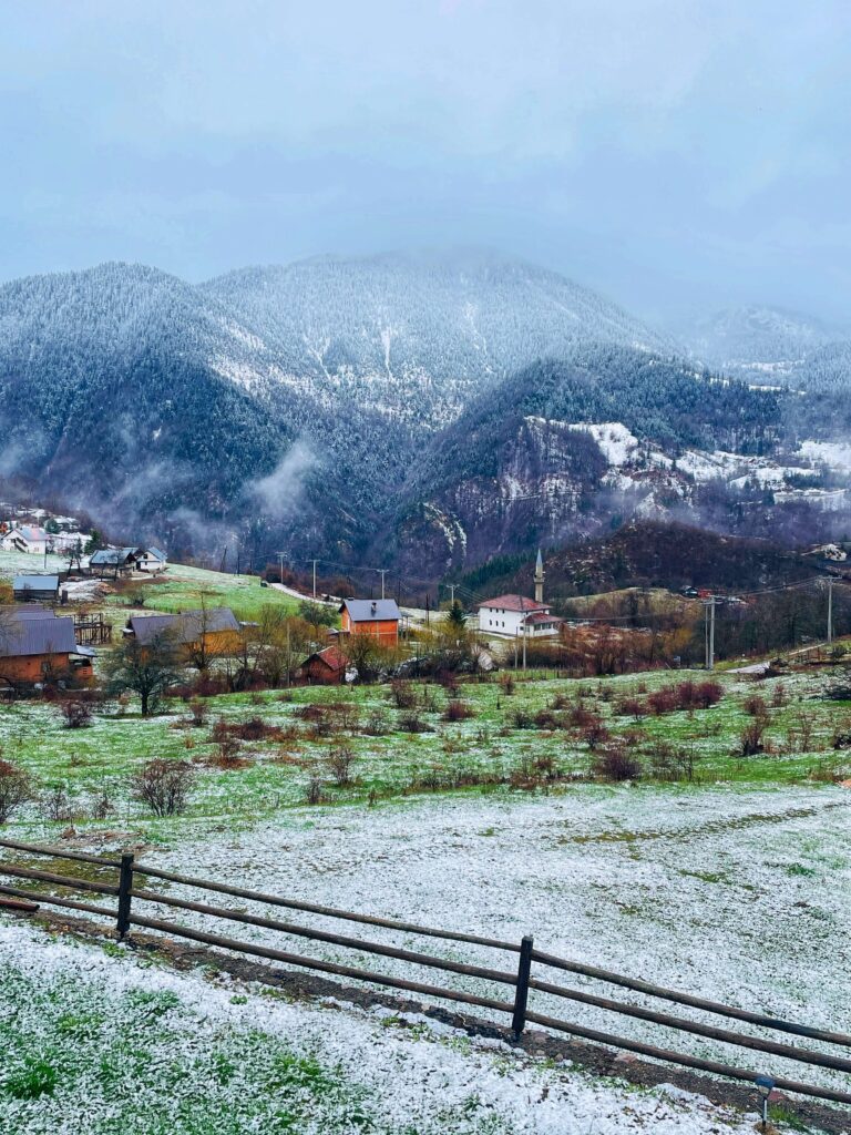 Solo female traveler exploring Peja in Kosovo with dramatic mountain cliffs
