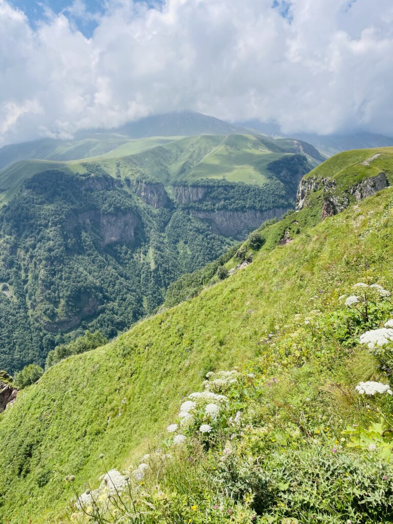 Solo female traveler hiking in Georgia with scenic mountain views in the Caucasus Mountains