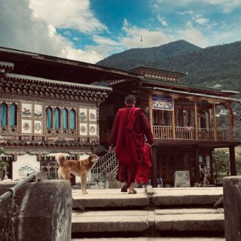 Buddhist monks overlooking the mountains in Bhutan during a solo female travel adventure