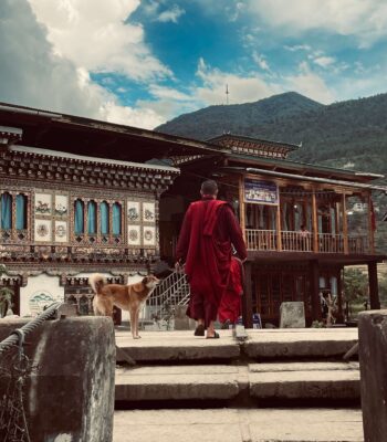 Buddhist monks overlooking the mountains in Bhutan during a solo female travel adventure