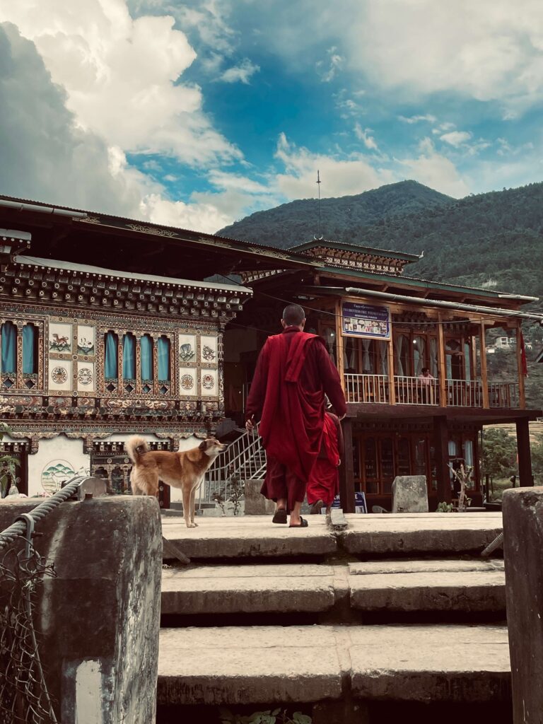 Buddhist monks overlooking the mountains in Bhutan during a solo female travel adventure