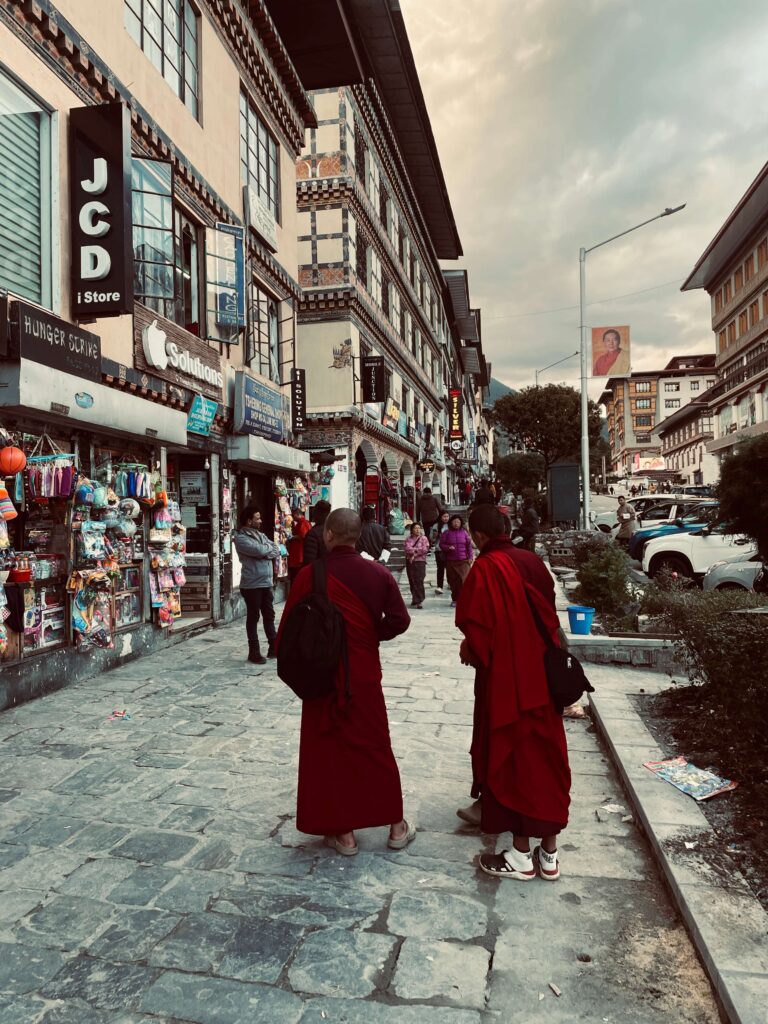 Buddhist monks overlooking the mountains in Bhutan during a solo female travel adventure