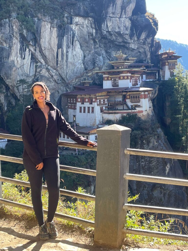Solo female traveler enjoying the view of Tiger’s Nest monastery in Bhutan
