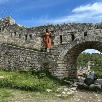 Solo female traveler exploring the UNESCO-listed old town of Berat, Albania.