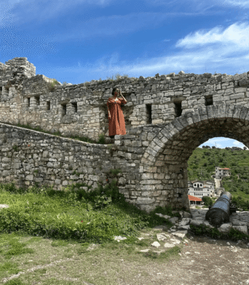 Solo female traveler exploring the UNESCO-listed old town of Berat, Albania.