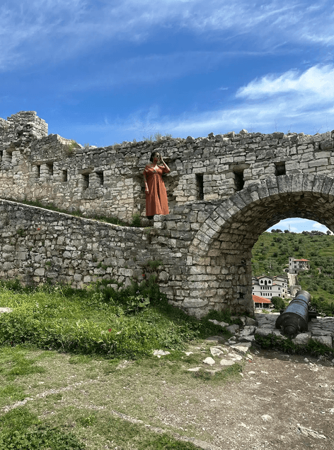 Solo female traveler exploring the UNESCO-listed old town of Berat, Albania.
