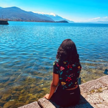 Solo female traveler exploring the beautiful Balkans with mountains and historic towns in summer.