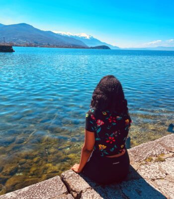 Solo female traveler exploring the beautiful Balkans with mountains and historic towns in summer.