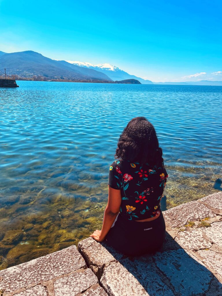 Solo female traveler exploring the beautiful Balkans with mountains and historic towns in summer.