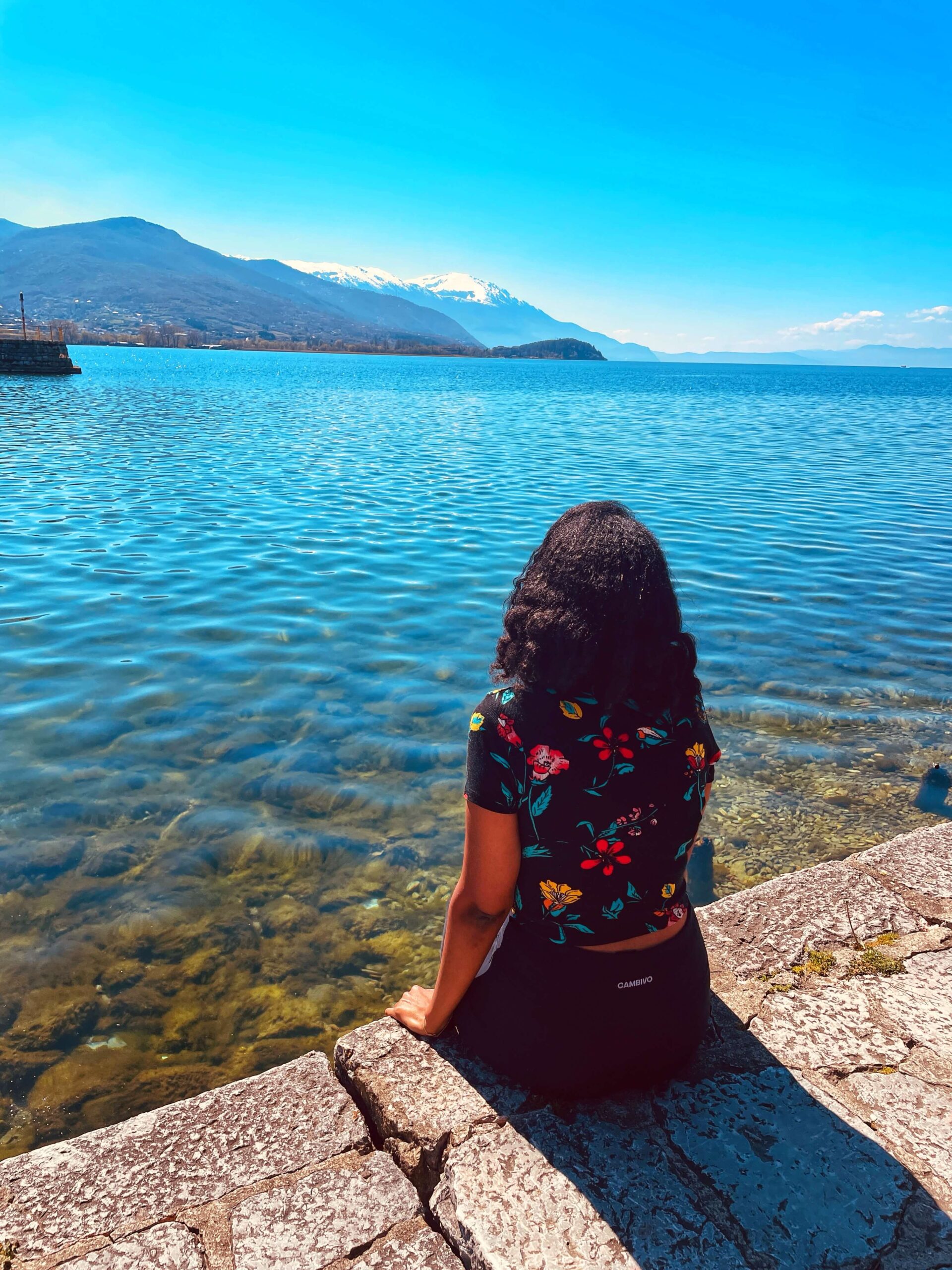 Solo female traveler exploring the beautiful Balkans with mountains and historic towns in summer.