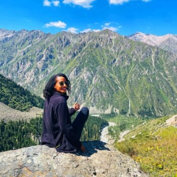 Solo female traveler hiking in Kyrgyzstan mountains