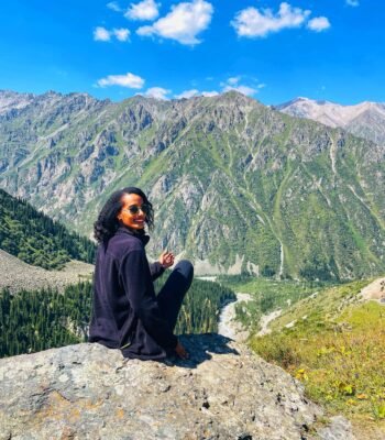 Solo female traveler hiking in Kyrgyzstan mountains