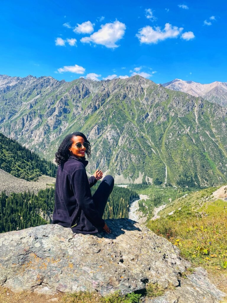 Solo female traveler hiking in Kyrgyzstan mountains