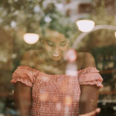 Female digital nomad working on laptop at a café