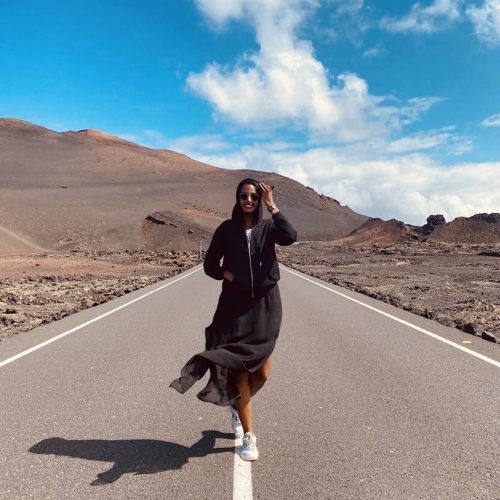 Solo female traveler hiking and enjoying nature in the mountains of Fuerteventura