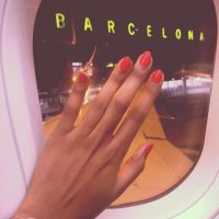 Solo female traveler sitting by Barcelona airport window