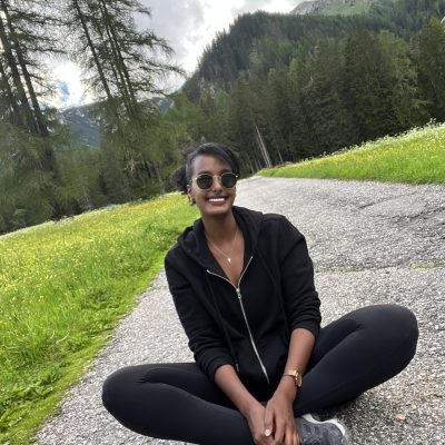 Solo female traveler taking a break while hiking in the Dolomites, Italy