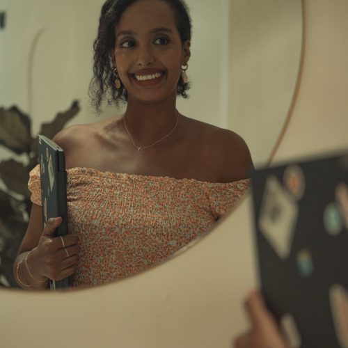 Solo female traveler working remotely from a coffee shop in Spain, digital nomad lifestyle